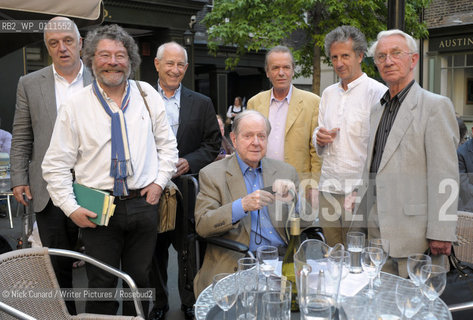 Martin Amis gatecrashes a photo featuring writers and poets reading from those post war  US and UK  writers known as The Movement. .They are [L-R] James Fenton, Craig Raine, Zach Leader , Robert Conquest [seatd wheelchair] , M.Amis, Blake Morrison, and Anthony Thwaite . Clive Wilmer also in attendance but not pictured here. ..copyright©Nick Cunard/Writer Pictures/Rosebud2