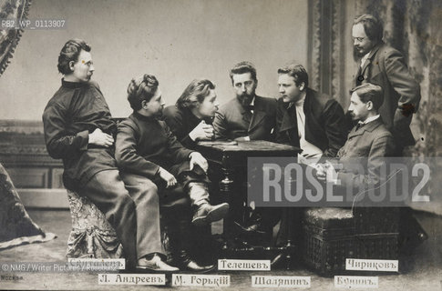 Maxim Gorky with unidentified group.  Gorky pictured leaning on table, left...Copyright©NMG/Writer Pictures/Rosebud2