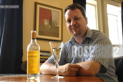 Philip Hensher, author and journalist, with a glass of Retsina at his home in Battersea, South London..©Rogan MacDonald/Writer Pictures/Rosebud2