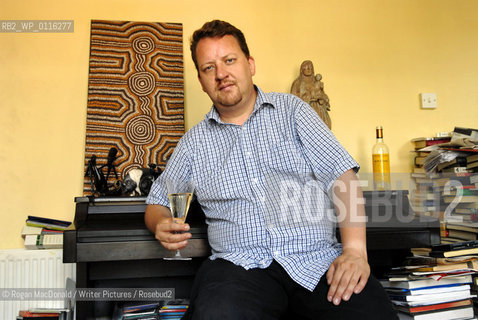 Philip Hensher, author and journalist, with a glass of Retsina at his home in Battersea, South London..©Rogan MacDonald/Writer Pictures/Rosebud2