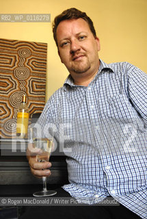 Philip Hensher, author and journalist, with a glass of Retsina at his home in Battersea, South London..©Rogan MacDonald/Writer Pictures/Rosebud2