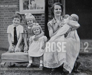Author Sara Maitland, her isolated cottage in moorland in Galloway in the background. Seen in front of her bookshelf...Collect with her mother and siblings Sara 2nd left (stripe dress, 3 years old).  ..L to R David, Sara, Frippy, mother Hope and baby Jamie (circa 1953.)..29th Oct 2008....Copyright©Robert Perry/TSPL/Writer Pictures/Rosebud2