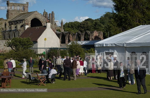 Borders Book Festival in Melrose..Guests enjoy the sunshine outside the Festival Marquee with Melrose Abbey visible in the background..Copyright©Alex Hewitt/Writer Pictures/Rosebud2