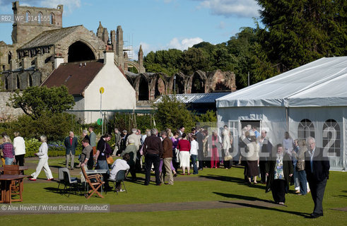 Borders Book Festival in Melrose..Guests enjoy the sunshine outside the Festival Marquee with Melrose Abbey visible in the background..Copyright©Alex Hewitt/Writer Pictures/Rosebud2