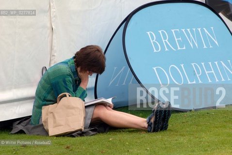 A visitor reading a new book in the sunshine during the Borders Book Fe©Writer Pictures/Rosebud2