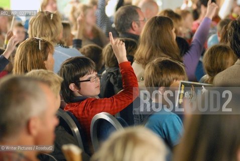 A young visitor raises his hand during the Horrid Henry session at th©Writer Pictures/Rosebud2