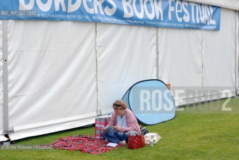 A visitor perusing the festival guide during the Borders Book Festival ©Writer Pictures/Rosebud2