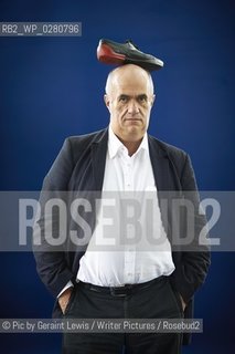 Colm Toibin, Poet and Writer, nominated for the Man Booker Long List 2013 with his shoe on his head  at The Edinburgh International Book  Festival 2013. 20th August 2013..©Pic by Geraint Lewis/Writer Pictures/Rosebud2