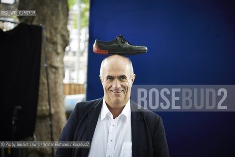 Colm Toibin, Poet and Writer, nominated for the Man Booker Long List 2013 with his shoe on his head  at The Edinburgh International Book  Festival 2013. 20th August 2013..©Pic by Geraint Lewis/Writer Pictures/Rosebud2