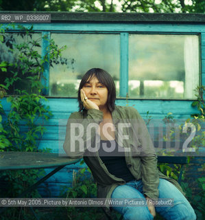 Ali Smith in her garden in Cambridge. .Smith is the author of The Accidental which was shortlisted for the Booker in 2005. She has published 2 other novels, Like and Hotel World..©5th May 2005..Picture by Antonio Olmos/Writer Pictures/Rosebud2