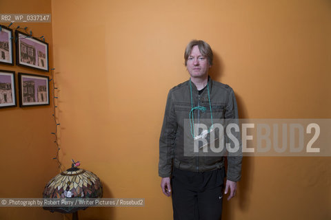 Michel Faber, author in his Edinburgh flat. 29th September 2014..©.Photograph by Robert Perry/Writer Pictures/Rosebud2