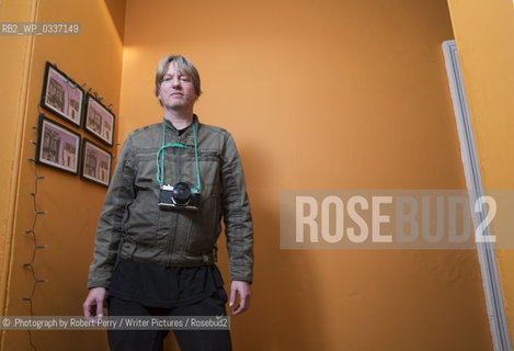 Michel Faber, author in his Edinburgh flat. 29th September 2014..©.Photograph by Robert Perry/Writer Pictures/Rosebud2