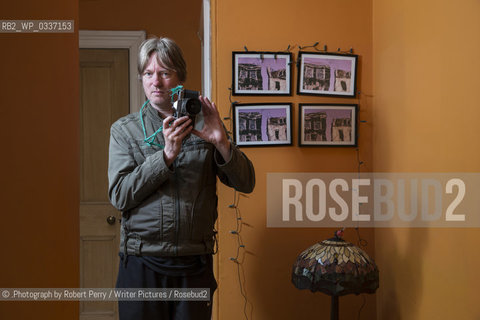 Michel Faber, author in his Edinburgh flat. 29th September 2014..©.Photograph by Robert Perry/Writer Pictures/Rosebud2