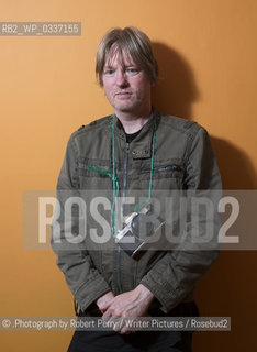 Michel Faber, author in his Edinburgh flat. 29th September 2014..©.Photograph by Robert Perry/Writer Pictures/Rosebud2