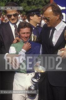 Rome, Capannelle Hippodrome, about 1988. Antonio Balzarini and his son Jo with Italian Derby winner/ Roma, Ippodromo le Capannelle, 1988 circa. Antonio Balzarini e il figlio Jo con il fantino vincitore del derby di galoppo - ©Marcello Mencarini/Rosebud2