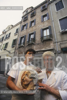 Venice, 1998. Pastry chefs Benito and Lorenzo Palombella holding a cake decorated with a Casanovas profile. Their cake shop is located on Barbaria delle Tole in the same building where is the last home of Giacomo Casanova in Venice / Venezia, 1998. Benito e Lorenzo Palombella, pasticceri, con una torta con il profilo di Casanova. Il loro negozio si trova in Barbaria delle Tole, nello stesso palazzo dove si trova lultima casa di Casanova a Venezia - ©Marcello Mencarini/Rosebud2