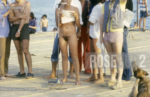 Castelporziano beach, Ostia (Rome), 1979. Nudists among the audience attending the First Festival of the Poets / Spiaggia di Castel Porziano, Ostia (Roma), 1979. Nudisti tra il pubblico che assiste al primo Festival dei poeti - ©Marcello Mencarini/Rosebud2