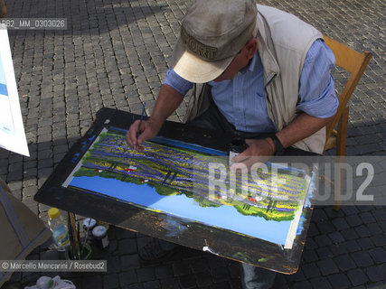 Rome, October 2012. Mirko, a painter of Piazza Navona,  where many painters expose and sell their works / Roma, ottobre 2012. Mirko, un pittore di piazza Navona, dove molti pittori espongono e vendono i loro lavori  - ©Marcello Mencarini/Rosebud2