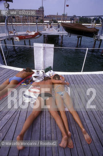 Venice Lido, Venice Film Festival about 1985. Bathers on the dock in front of the Excelsior Hotel / Lido di Venezia, Mostra del Cinema di Venezia 1985 circa. Bagnanti sul pontile dellHotel Excelsior - ©Marcello Mencarini/Rosebud2