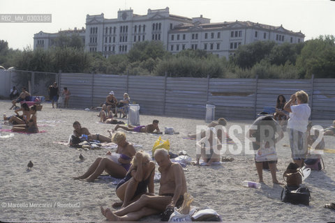 Venice Lido, Venice Film Festival about 1985. Bathers on the beach in front of the Des Bains Hotel / Lido di Venezia, Mostra del Cinema di Venezia 1985 circa. Bagnanti sulla spiaggia davanti allHotel des Bains - ©Marcello Mencarini/Rosebud2