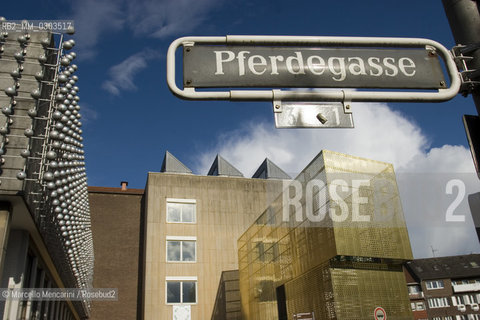 Münster, at the corner of An der Rothenburg and Pferdegasse. Switch+ by Jan Kampshoff and Marc Günnewig, a temporary structure created for the plaza in front of the former Westphalian Museum of Archaeology that offers a central location for services related to exhibition, including an information point and a bookshop. On the left, Silberne Frequenz (Silver Frequency) by Otto Piene, a relief on the façade of the LWL-State Museum of art and cultural history - ©Marcello Mencarini/Rosebud2