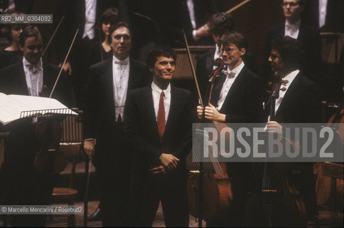 Ferrara, 10 November 1990. Composer Marco Stroppa receives applause after the performance of his work Metabolai by conductor Claudio Abbado (behind him in the picture) with the Chamber Orchestra of Europe / Ferrara, 10 novembre 1990. Il Compositore Marco Stroppa riceve gli applausi del pubblico dopo lesecuzione del suo brano Metabolai diretto da Claudio Abbado, dietro di lui nella foto, ed eseguito dalla Chamber Orchestra of Europe - ©Marcello Mencarini/Rosebud2