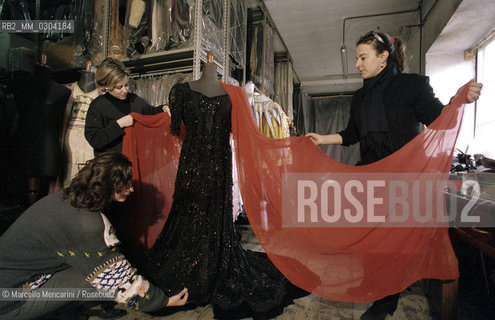 Rome Opera House, January 8, 2000. Costume designer Anna Biagiotti and her assistants show a costume designed for the first performance of Tosca by Giacomo Puccini, on occasion of the performance of this opera in the same theater of its debut, hundred years after (directed by Franco Zeffirelli, conducted by Placido Domingo, starring Ines Salazar and Luciano Pavarotti) / Roma, Teatro dellOpera, 8 gennaio 2000. La costumista Anna Biagiotti e le sue assistenti mostrano un costume creato per la prima rappresentazione dellopera Tosca di Giacomo Puccini in occasione della sua esecuzione nello stesso teatro del debutto cento anni dopo (regia: Franco Zeffirelli, direttore dorchestra: Placido Domingo, protagonisti: Ines Salazar e Luciano Pavarotti) - ©Marcello Mencarini/Rosebud2