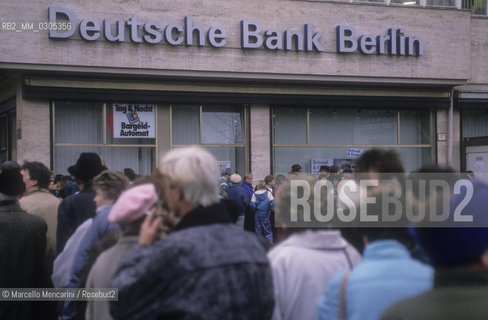 East Berlin, 1989. Citizens of the East Germany in the queue at the counter of a West Berlin bank to collect a bonus of 100 marks, gift of the West Germany after the opening of the border between East Germany and West Germany / Berlino Est, 1989. Cittadini della Germania Est in coda allo sportello di una banca di Berlino Ovest per riscuotere un bonus di 100 marchi, regalo della Germania Ovest dopo lapertura delle frontiere tra Germania Est e Germania Ovest - ©Marcello Mencarini/Rosebud2