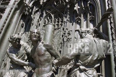 Panel of the main bronze door of the Duomo di Milano designed by Lodovico Pogliaghi: The Flagellation of Christ, located on the left shutter, it is part of the series of Virgin Marys Pains / Formella in bronzo della Porta maggiore del Duomo di Milano ideata da Lodovico Pogliaghi: la flagellazione di Cristo, posta sul battente di sinistra, fa parte della serie dei Dolori della Vergine Maria - ©Marcello Mencarini/Rosebud2