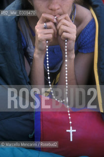 Rome, Tor Vergata, August 20, 2000. .Jubilee of young people. Girl praying / Roma, Tor Vergata, 20 agosto 2000. Giubileo dei giovani. Ragazza che prega - ©Marcello Mencarini/Rosebud2