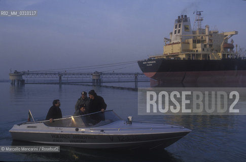 Venice, San Leonardo Port, about 1990. A boat of the Venice lagoon guards and, in the background, a tanker unloading / Venezia, porto di San Leonardo, 1990 circa. Una barca delle guardie lagunari e, sullo sfondo, una petroliera durante lo scarico - ©Marcello Mencarini/Rosebud2