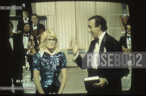 Image from TV of Italian host Pippo Baudo and showgirl Heather Parisi during the program Fantastico 5 (1984) / Immagine dalla TV del presentatore Pippo Baudo e la showgirl Heather Parisi durante la trasmissione Fantastico 5 (1984) - ©Marcello Mencarini/Rosebud2