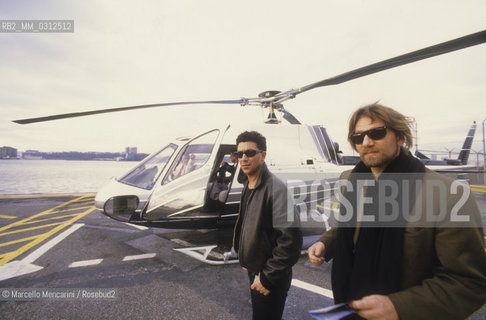 New York, 1987. Italian singer and songwriter Edoardo Bennato and percussionist Toni Esposito near a helicopter / New York, 1987. Il cantante Edoardo Bennato e il percussionista Toni Esposito vicino a un elicottero - ©Marcello Mencarini/Rosebud2
