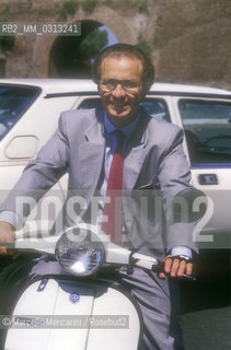 Italian journalist Luigi Bisignani riding a Vespa scooter, 1988 / Il giornalista Luigi Bisignani in Vespa, 1988 - ©Marcello Mencarini/Rosebud2
