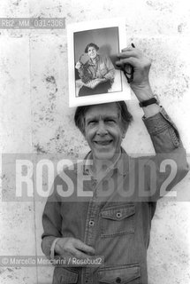 Roma, 1983. American composer John Cage holding a photo of him taken in the previous year in Venice by the same photographer / Roma, 1983. Il compositore John Cage tiene in mano una sua foto scattata lanno precedente a Venezia dallo stesso fotografo - ©Marcello Mencarini/Rosebud2