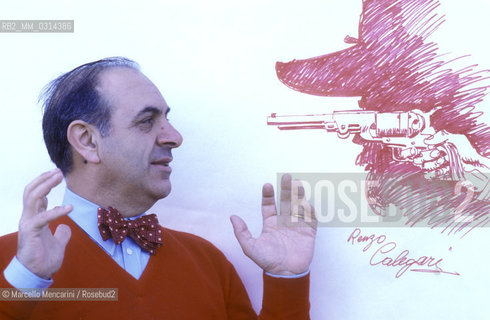 Lucca, 1984. Italian cartoonist Renzo Calegari posing next to one of his drawing / Lucca, 1984. Il fumettista Renzo Calegari posa accanto a un suo disegno - ©Marcello Mencarini/Rosebud2