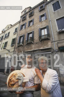 Venice, 1998. Pastry chefs Benito and Lorenzo Palombella holding a cake decorated with a Casanovas profile. Their cake shop is located on Barbaria delle Tole in the same building where is the last home of Giacomo Casanova in Venice / Venezia, 1998. Benito e Lorenzo Palombella, pasticceri, con una torta con l profilo di Casanova. Il loro negozio si trova in Barbaria delle Tole, nello stesso palazzo dove si trova lultima casa di Casanova a Venezia - ©Marcello Mencarini/Rosebud2