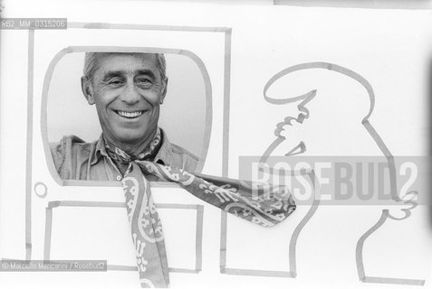 Lucca, 1984. Italian cartoonist Osvaldo Cavandoli posing next to a drawing of his character La Linea (The Line) / Lucca, 1984. Il disegnatore di fumetti Osvaldo Cavandoli posa accanto a un disegno del suo personaggio La Linea - ©Marcello Mencarini/Rosebud2