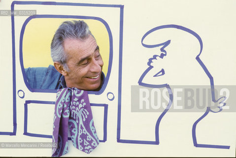 Lucca, 1984. Italian cartoonist Osvaldo Cavandoli posing next to a drawing of his character La Linea (The Line) / Lucca, 1984. Il disegnatore di fumetti Osvaldo Cavandoli posa accanto a un disegno del suo personaggio La Linea - ©Marcello Mencarini/Rosebud2
