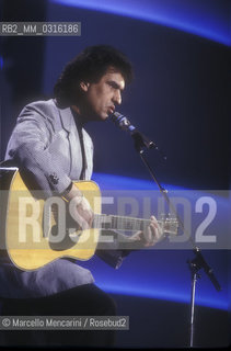 Sanremo Music Festival 1989. Italian pop singer Toto Cutugno performing the song Le mamme, that will finish second / Festival di Sanremo 1989. Toto Cutugno canta la canzone Le mamme, che si classificherà al secondo posto - ©Marcello Mencarini/Rosebud2