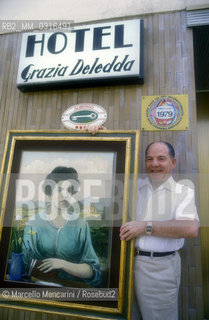 Owner of Grazia Deledda Hotel in Nuoro shows a portrait of writer / Il proprietario del Grazia Deledda Hotel di Nuoro mostra un ritratto della scrittrice - ©Marcello Mencarini/Rosebud2