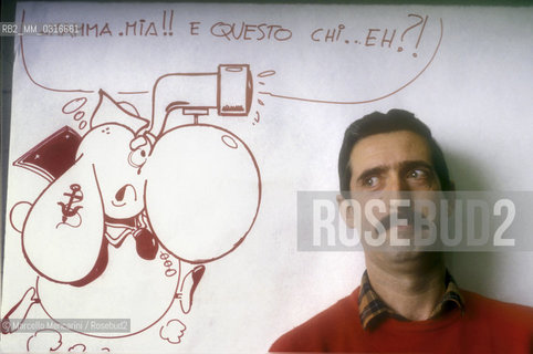 Lucca, 1984. Italian cortoonist Fabrizio Del Tessa posing next to one of his drawing / Lucca, 1984. Fabrizio Del Tessa, disegnatore di fumetti posa accanto a un suo disegno - ©Marcello Mencarini/Rosebud2