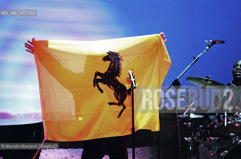 Milan, October 21, 1999. British singer Jay Kay from Jamiroquai raises the Ferrari flag at TV program Francamente me ne infischio / Milano, 21 ottobre 1999. Jason Kay, leader e cantante dei Jamiroquai, alza la bandiera della Ferrari durante il programma televisivo Francamente me ne infischio - ©Marcello Mencarini/Rosebud2