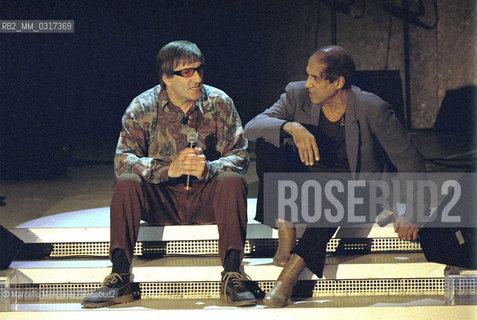 Milan, October 28, 1999. Italian pop singer Adriano Celentano on the set of his TV program Francamente me ne infischio with singer Pio Trebbi (on the left) / Milano, 28 ottobre 1999. Il cantante Adriano Celentano sul set del suo programma televisivo Francamente me ne infischio con il cantante Pio Trebbi (a sinistra) - ©Marcello Mencarini/Rosebud2
