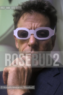 Rome, 1998. American composer Philip Glass wearing glasses to see three-dimensional images. He is in Rome at the Olympic Theater for the 3D opera Monsters of Grace, composed by him with Bob Wilson / Roma, 1998. Il compositore Philip Glass con degli occhiali per immagini tridimensionali, a Roma al Teatro Olimpico con lopera Monster of Grace, scritta da lui in collaborazione con Bob Wilson - ©Marcello Mencarini/Rosebud2