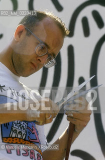 Artist Keith Haring working at the mural Tuttomondo on the rear wall of the Church of SantAntonio in Pisa, 1989 / Lartista Keith Haring mentre lavora al murale Tuttomondo sul muro posteriore della chiesa di SantAntonio abate a Pisa, 1989 - ©Marcello Mencarini/Rosebud2