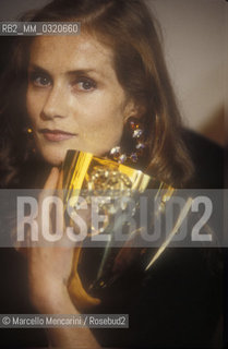 Venice Lido, Venice Film Festival 1988. French actress Isabelle Huppert receiving Coppa Volpi for Best Actress for her role in Une affaire de femmes (Story of Women), directed by Claude Chabrol / Lido di Venezia, Mostra del Cinema di Venezia 1988. Lattrice francese Isabelle Huppert riceve la coppa Volpi come migliorte attrice per la sua interpretazione in Une affaire de femmes (Un affare di donne), diretto da Claude Chabrol - ©Marcello Mencarini/Rosebud2