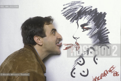 Lucca, 1986. Italian comics author and illustrator Tanino Liberatore posing next to one of his drawing / Lucca, 1986. Tanino Liberatore, disegnatore di fumetti  posa accanto a un suo disegno - ©Marcello Mencarini/Rosebud2