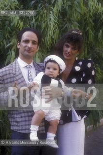 Comic actor Andy Luotto with his wife Antonietta D’Angeli and their first son Eugene on the Baptism day, 1986 / Lattore comico Andy Luotto con sua moglie Antonietta D’Angeli e il loro primo figlio Eugene nel giorno del battesimo, 1986 - ©Marcello Mencarini/Rosebud2