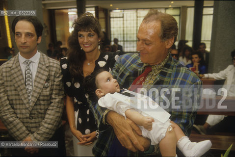 Comic actor Andy Luotto and his wife at their sons Christening, Italian showman Renzo Arbore as godfather, 1986 / Lattore comico Andy Luotto esua moglie al battesimo del loro figlio, padrino Renzo Arbore, 1986 - ©Marcello Mencarini/Rosebud2